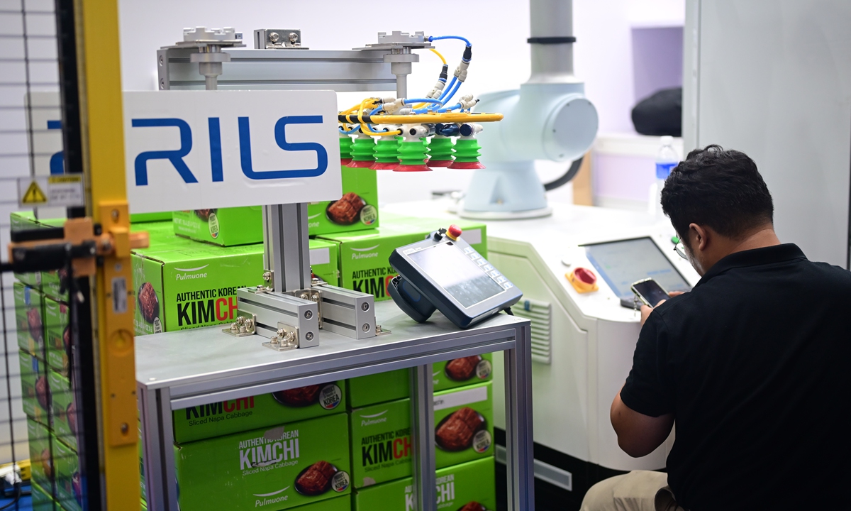 A worker from South Korean BRILS Corp checks exhibition equipment at the 2024 World Robot Conference held on August 21, 2024 in Beijing. Photo: Tao Mingyang/GT