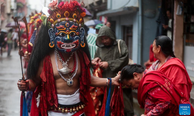 A masked dancer takes part in a parade during the Khadga Jatra festival in Kathmandu, Nepal, Aug. 21, 2024. (Photo: Xinhua)