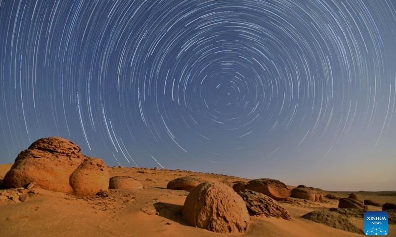 This composite photo taken on Aug. 23, 2024 shows star trails over the desert in Watermelon Valley of Fayoum, Egypt. (Xinhua/Liu Minhao)