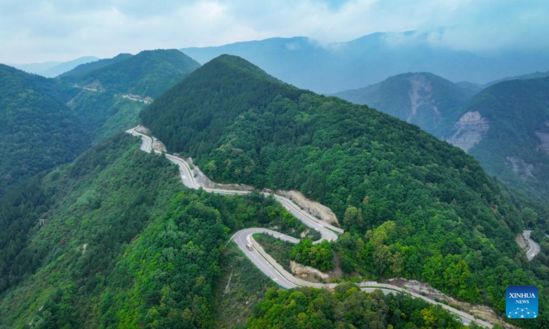 This aerial drone photo taken on Aug. 24, 2024 shows people visiting Liupanshan National Forest Park by tour bus in Guyuan City, northwest China's Ningxia Hui Autonomous Region. (Xinhua/Feng Kaihua)

