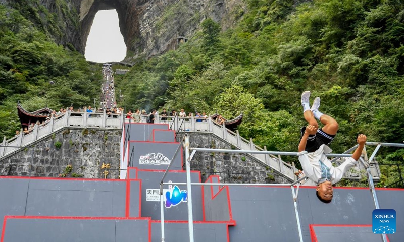 China's Ankarjan competes during the 2024 Parkour on the Highest Ladder at the Tianmen Mountain National Forest Park in Zhangjiajie, central China's Hunan Province, on Aug 25, 2024. (Xinhua/Chen Zeguo)