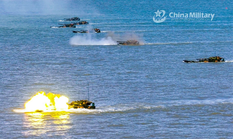 Amphibious armored infantry fighting vehicles (IFVs) attached to a brigade with the PLA Army fire at mock targets during a live-fire training exercise on July 30, 2024. (eng.chinamil.com.cn/Photo by Ma Hailin)