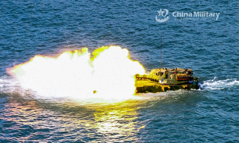 An amphibious armored infantry fighting vehicle (IFV) attached to a brigade with the PLA Army fires at mock targets during a live-fire training exercise on July 30, 2024. (eng.chinamil.com.cn/Photo by Ma Hailin)