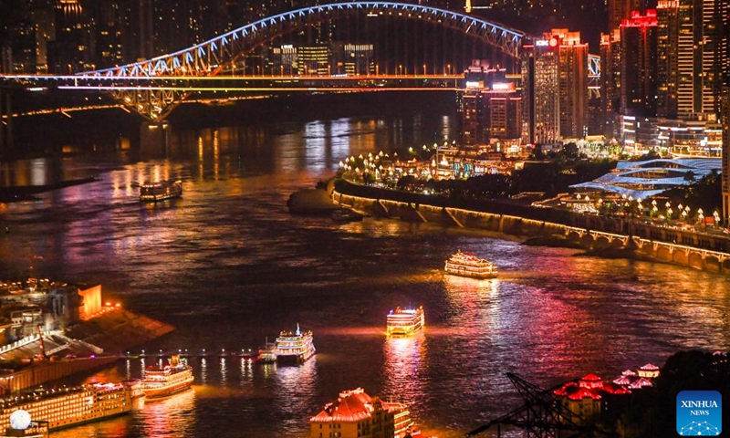 Tourists take boats to enjoy the night view in Chongqing, southwest China, Aug. 21, 2024. Renowned tourist destinations in Chongqing, a city known for its high temperatures, attract many tourists in summer. (Xinhua/Wang Quanchao)