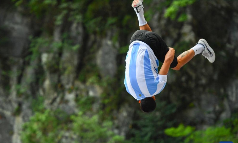 Argentina's Lautaro Chialvo competes during the 2024 Parkour on the Highest Ladder at the Tianmen Mountain National Forest Park in Zhangjiajie, central China's Hunan Province, on Aug 25, 2024. (Xinhua/Chen Zeguo)