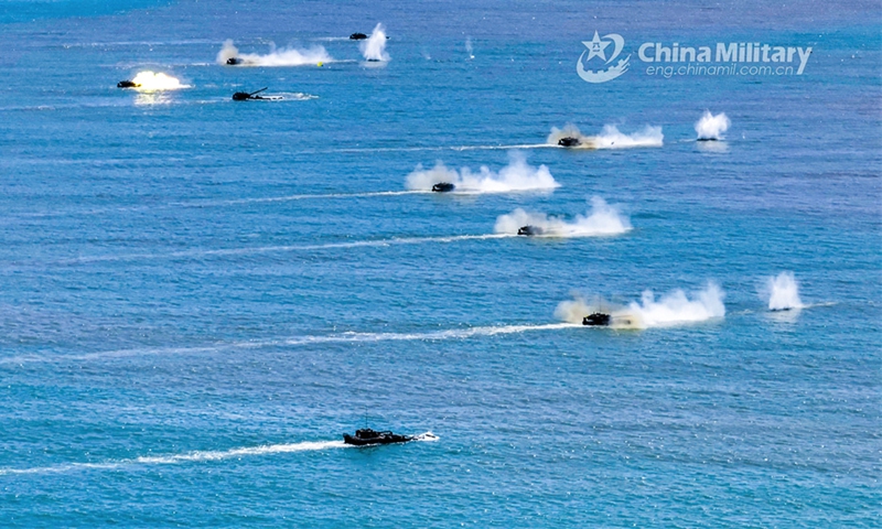 Amphibious armored infantry fighting vehicles (IFVs) attached to a brigade with the PLA Army maneuver in ferrying and assault wave formation during a live-fire training exercise on July 30, 2024. (eng.chinamil.com.cn/Photo by Ma Hailin)