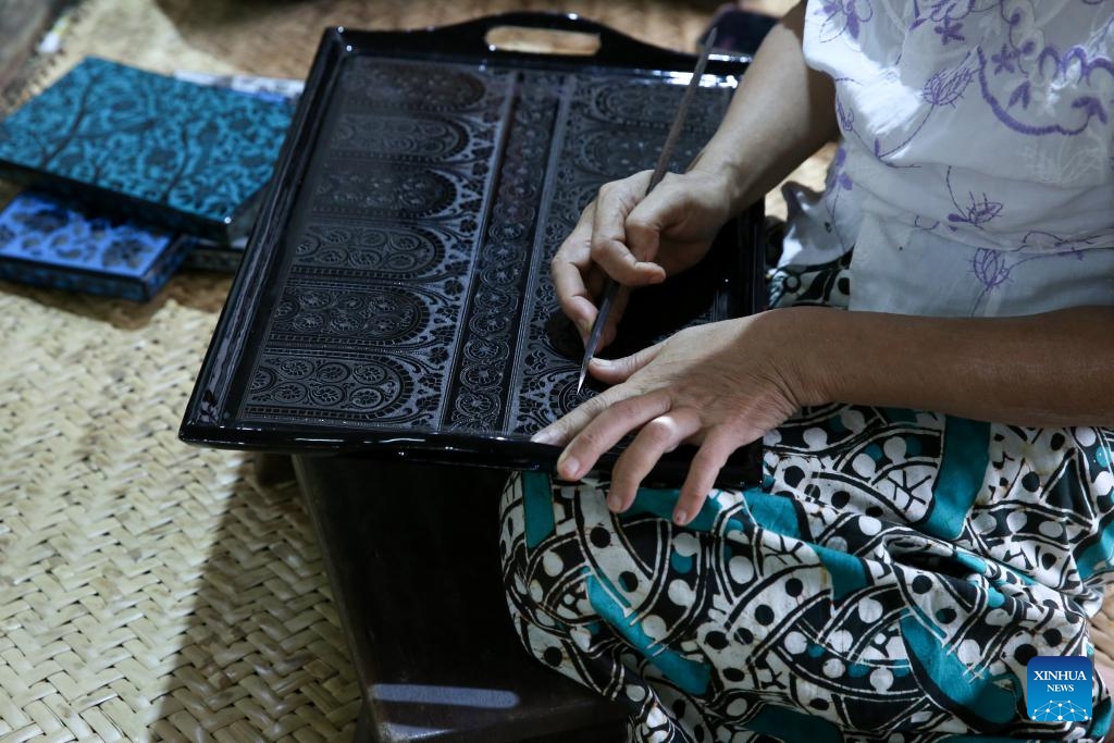 A woman carves on a lacquerware at a workshop in Bagan, Myanmar, Aug. 24, 2024. (Photo: Xinhua)