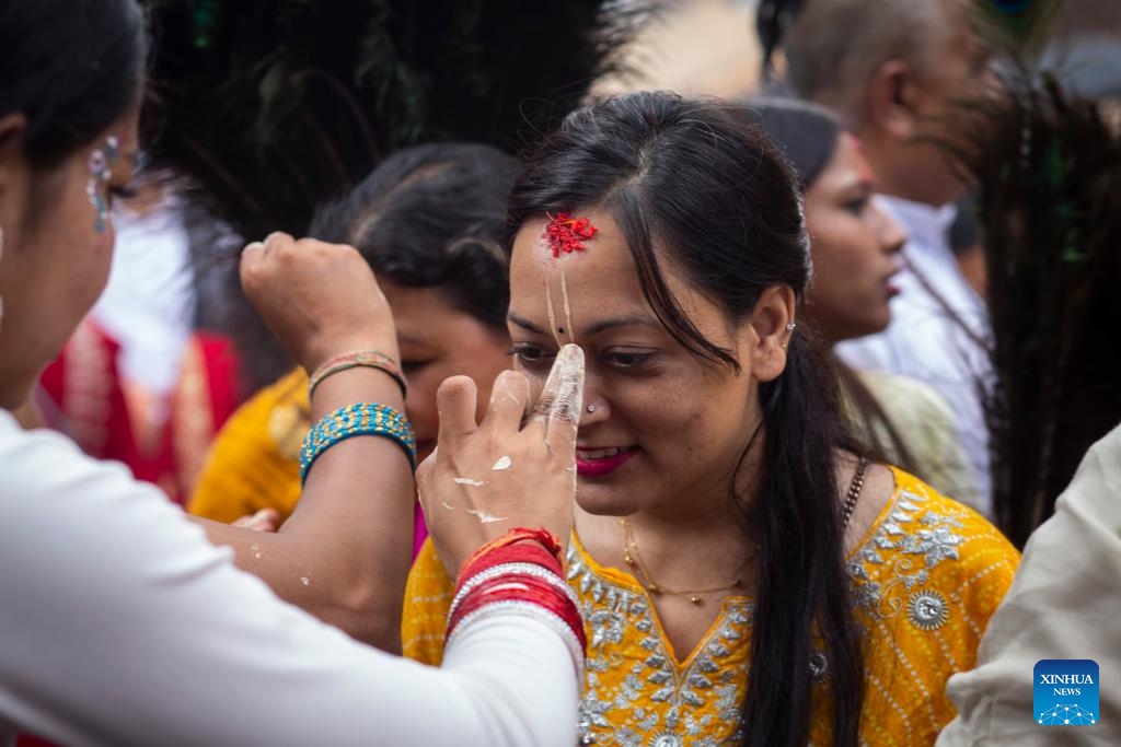 A devotee has her face decorated during the Krishna Janmashtami festival in Lalitpur, Nepal, Aug. 26, 2024. Krishna Janmashtami festival is celebrated annually to mark the birth anniversary of Hindu God Krishna. (Photo: Xinhua)