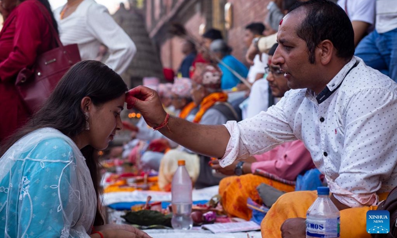 A devotee receives tika during the Krishna Janmashtami festival in Lalitpur, Nepal, Aug. 26, 2024. Krishna Janmashtami festival is celebrated annually to mark the birth anniversary of Hindu God Krishna. (Photo: Xinhua)