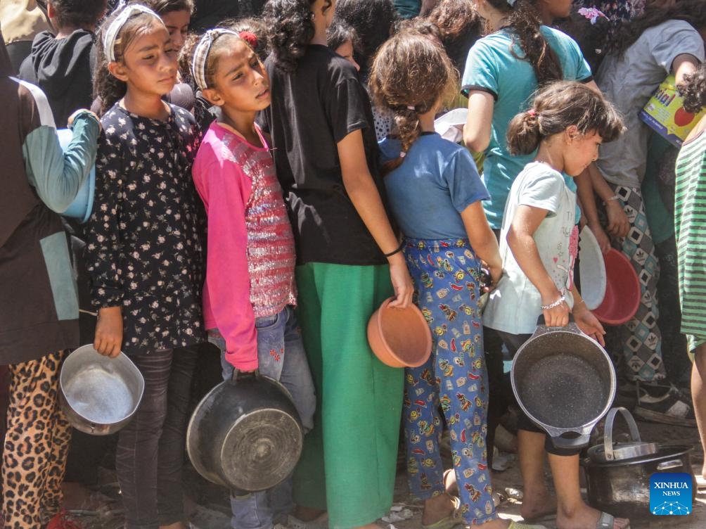 Children gather to receive food relief in the Jabalia refugee camp in the northern Gaza Strip, on Aug. 26, 2024. The UN Office for the Coordination of Humanitarian Affairs (OCHA) said on Aug. 23 that humanitarian partners working to provide nutrition reported the number of children in northern Gaza who were diagnosed with acute malnutrition soared by over 300 percent last month compared to May -- and by more than 150 percent in the south. (Photo: Xinhua)