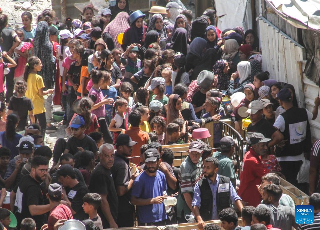 People gather to receive food relief in the Jabalia refugee camp in the northern Gaza Strip, on Aug. 26, 2024. The UN Office for the Coordination of Humanitarian Affairs (OCHA) said on Aug. 23 that humanitarian partners working to provide nutrition reported the number of children in northern Gaza who were diagnosed with acute malnutrition soared by over 300 percent last month compared to May -- and by more than 150 percent in the south. (Photo: Xinhua)