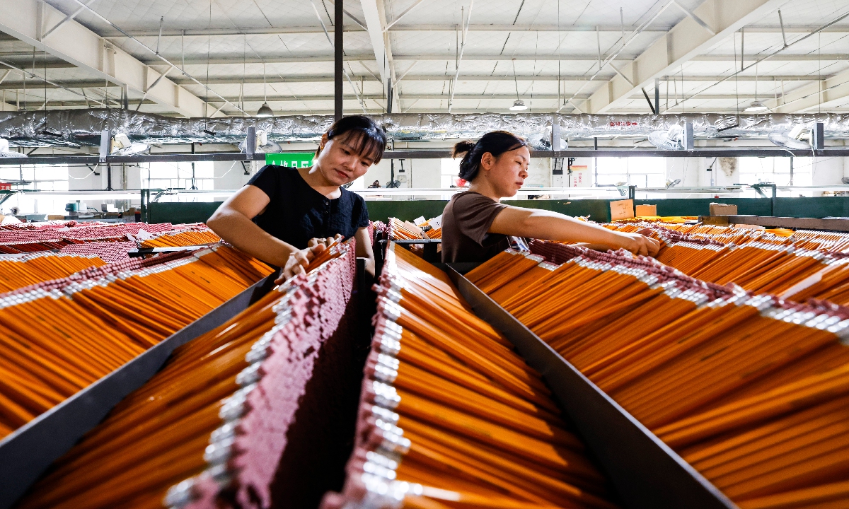 Workers rush to fill pencil orders at a workshop in Suqian, East China's Jiangsu Province on August 27, 2024. As most Chinese schools will open for the new year soon, the pencil producer has been working overtime to make graphite pencils, colored pencils and art pencils to meet market demand. Photo: VCG