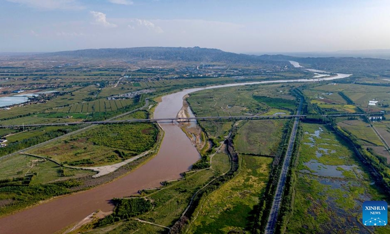 An aerial drone photo taken on Aug. 23, 2024 shows a section of the Yellow River in Qingtongxia City, northwest China's Ningxia Hui Autonomous Region. In recent years, Ningxia has attached great importance to the protection and management of the Yellow River. The region has stepped up efforts to improve the ecological environment in the watershed areas of the river. (Photo: Xinhua)