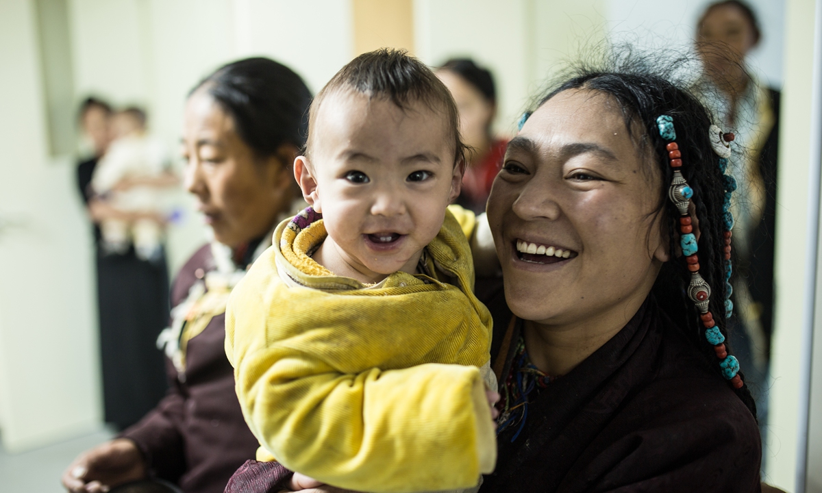 A mother and son smile at the camera at Nagqu People's Hospital in northern Xizang, in October 2024. Photo: Shan Jie/GT