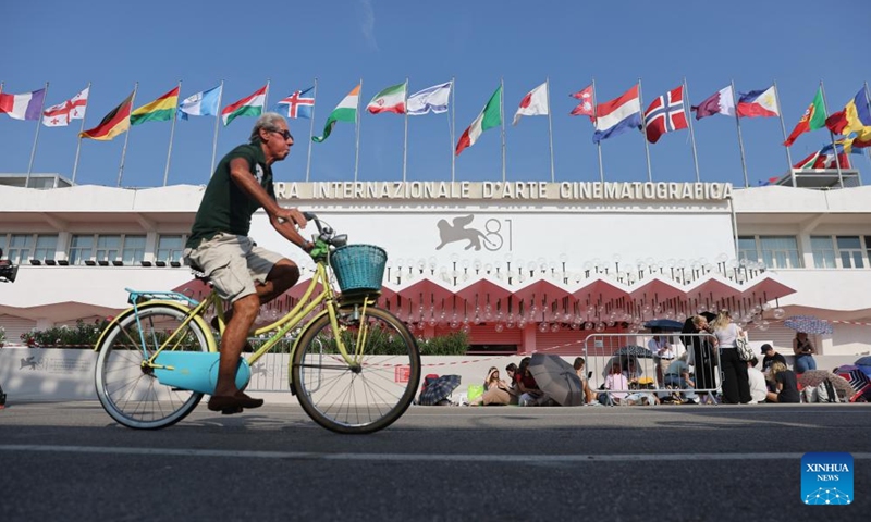 A man rides past the Palazzo del Cinema on Lido Island, in Venice, Italy, Aug. 28, 2024. The 81st Venice Film Festival will run from Aug. 28 until Sept. 7 at the Venice Lido island. (Photo: Xinhua)