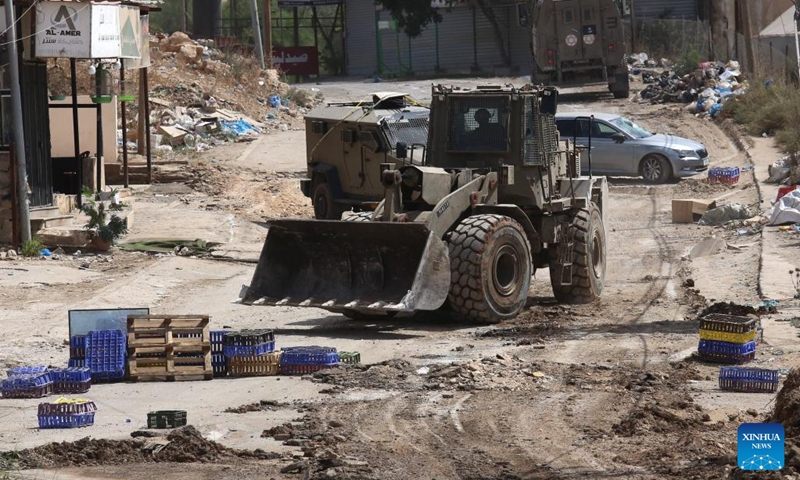 Israeli military vehicles are seen during an Israeli operation in the Far'a refugee camp, to the south of the northern West Bank city of Tubas, on Aug. 28, 2024. At least 10 Palestinians were killed on Wednesday by Israeli shelling and gunfire in the northern West Bank, according to the Ramallah-based Palestinian Health Ministry. (Photo: Xinhua)