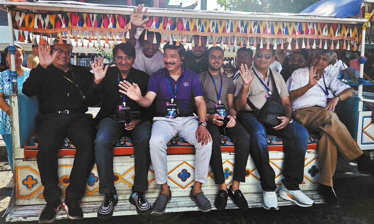 Pakistani journalists ride a horse-drawn carriage at the tourism area in Yining, Northwest China's Xinjiang Uygur Autonomous Region, on August 22, 2024. Photo: Zhang Yuying/GT