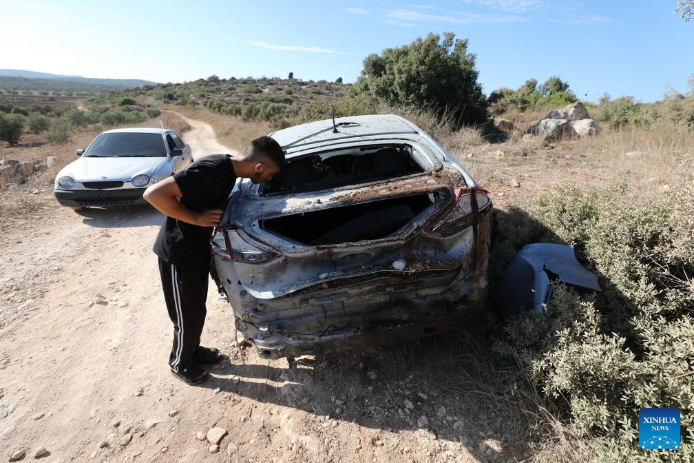 A Palestinian man inspects a vehicle attacked by Israeli warplanes in the Sir village, to the south of the northern West Bank city of Jenin, on Aug. 28, 2024. At least 10 Palestinians were killed on Wednesday by Israeli shelling and gunfire in the northern West Bank, according to the Ramallah-based Palestinian Health Ministry. (Photo: Xinhua)