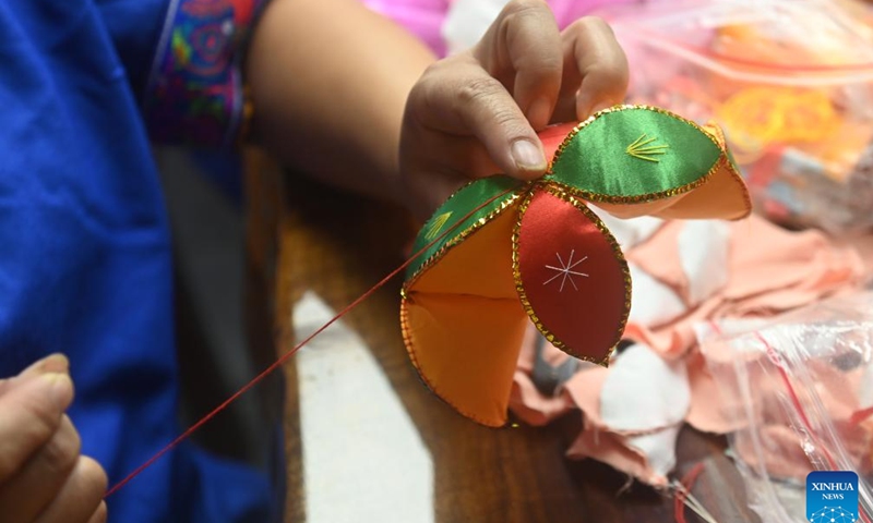 A resident makes an embroidered ball in Xinjing Township of Jingxi City, south China's Guangxi Zhuang Autonomous Region, Aug. 27, 2024. Embroidered balls from Jingxi are well received nationwide due to their exquisite design and craftsmanship, which are uaually stuffed with spices or herbal medicines. (Photo: Xinhua)