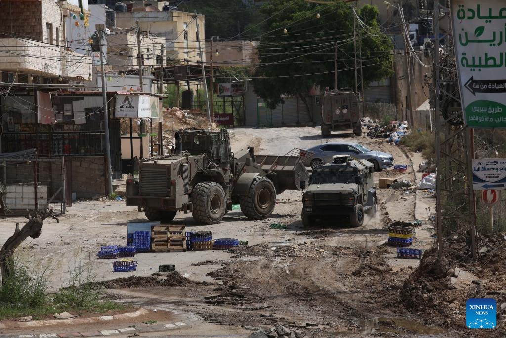 Israeli military vehicles are seen during an Israeli operation in the northern West Bank city of Jenin, on Aug. 28, 2024. At least 10 Palestinians were killed on Wednesday by Israeli shelling and gunfire in the northern West Bank, according to the Ramallah-based Palestinian Health Ministry. (Photo: Xinhua)