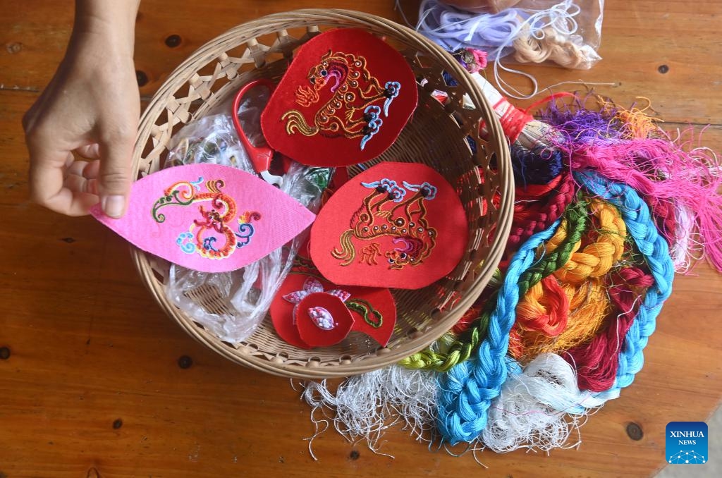 A resident makes an embroidered ball in Xinjing Township of Jingxi City, south China's Guangxi Zhuang Autonomous Region, Aug. 27, 2024. Embroidered balls from Jingxi are well received nationwide due to their exquisite design and craftsmanship, which are uaually stuffed with spices or herbal medicines. (Photo: Xinhua)