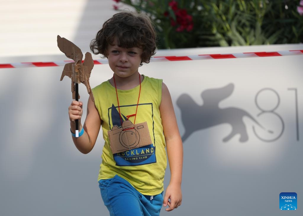 A boy poses for a photo in front of the Palazzo del Cinema on Lido Island, in Venice, Italy, Aug. 28, 2024. The 81st Venice Film Festival will run from Aug. 28 until Sept. 7 at the Venice Lido island. (Photo: Xinhua)