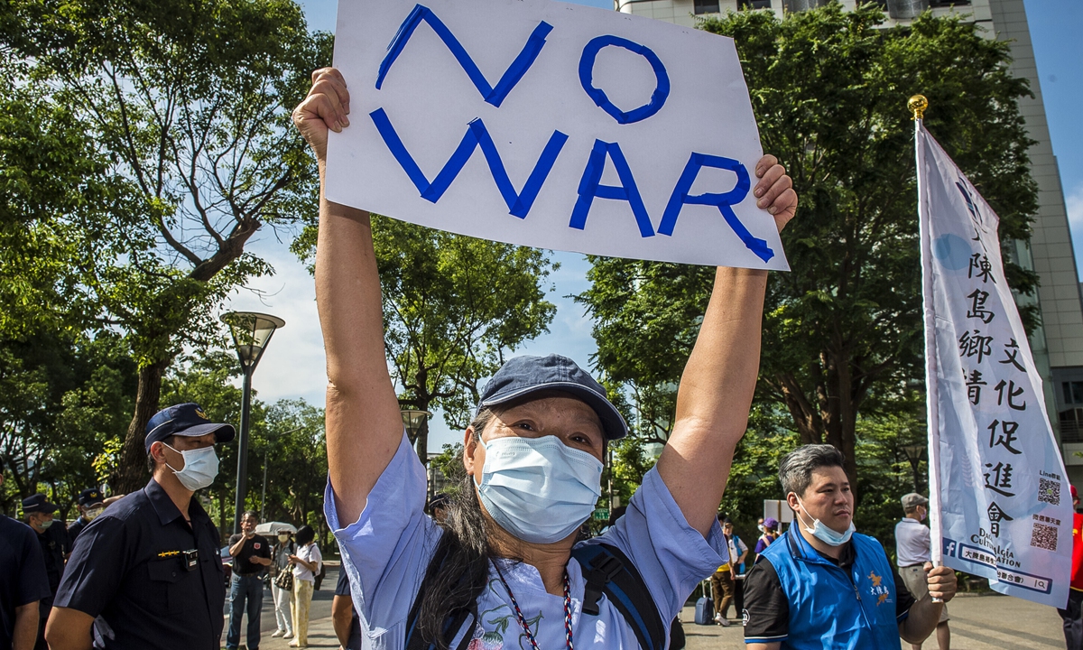 A resident on the island of Taiwan holds a banner reading 