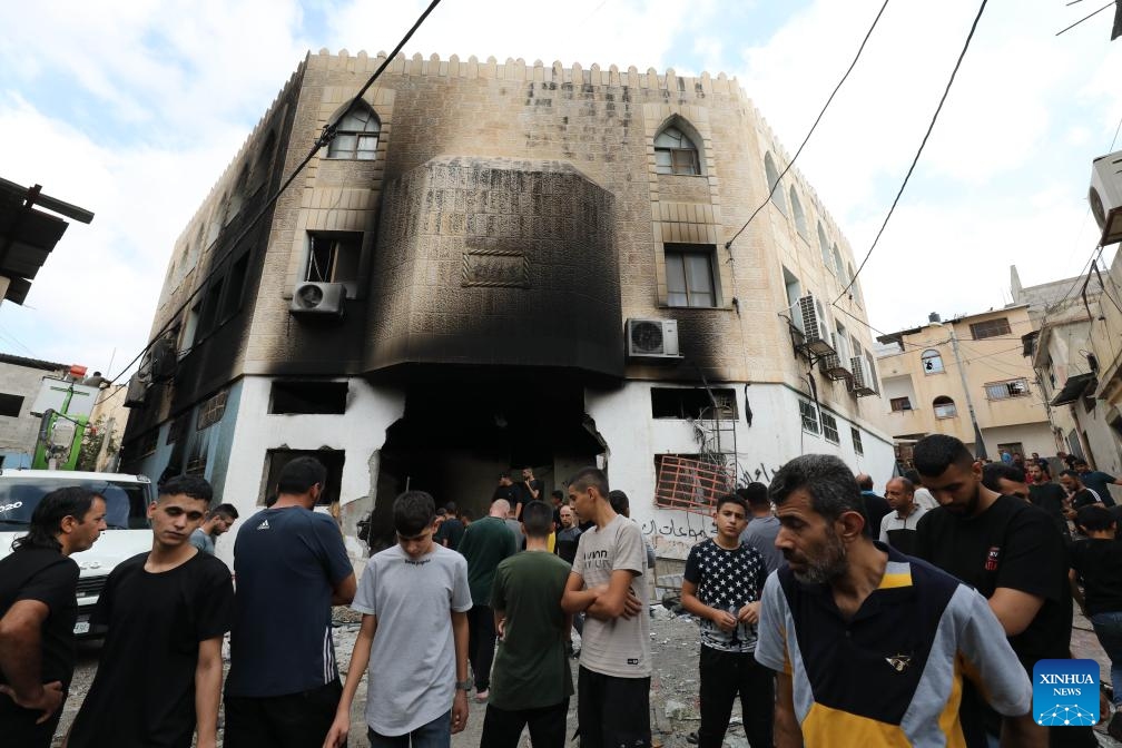 People gather at a building damaged by Israeli army in Far'a refugee camp, northern West Bank, on Aug. 29, 2024. The Israeli army withdrew from the Far'a refugee camp south of Tubas following its raid that killed four Palestinians and destructed homes and infrastructure, the sources told Xinhua on Thursday. (Photo: Xinhua)