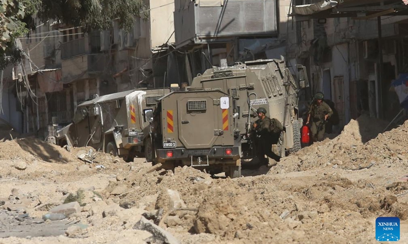 Israeli troops are seen on a street during a military operation in the Nour Shams refugee camp, east of the city of Tulkarm in the West Bank, on Aug. 29, 2024. According to Palestinian and Israeli sources, the Israeli army on Wednesday launched a large-scale military operation in Tulkarm, Jenin, and Tubas refugee camps in an attempt to arrest wanted persons accused of involvement in operations against Israel. (Photo: Xinhua)