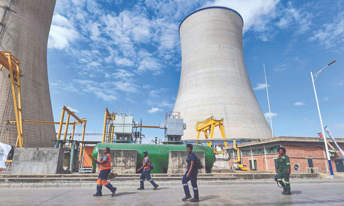 Smoke billows from the cooling tower at the coal fired power-generator built with a Chinese company on August 3, 2023, in Hwange, Zimbabwe. The newly commissioned expansion generates 600MW easing power outages in the country. Photo: VCG