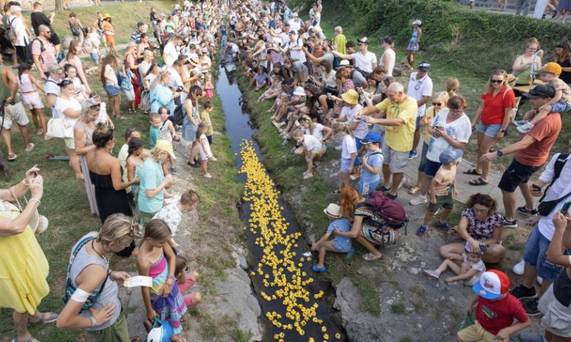 People watch a rubber duck race, also a charity event, in Szentendre, Hungary, on Aug. 31, 2024. (Photo by Attila Volgyi/Xinhua)