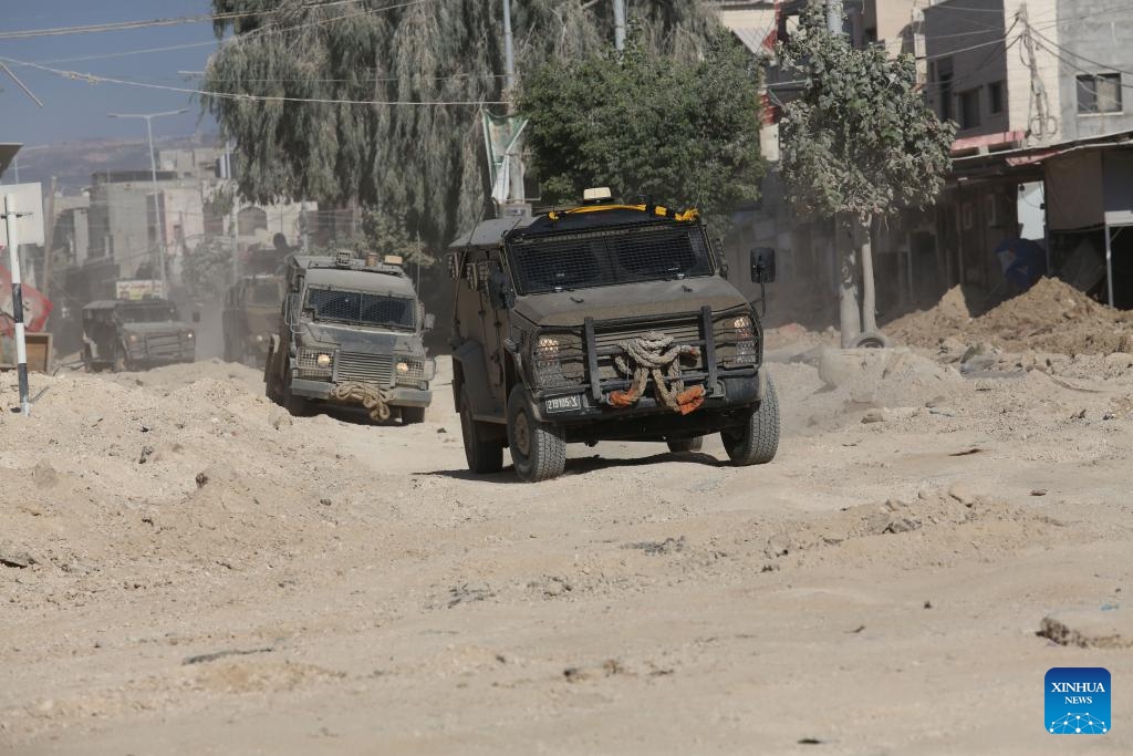 Israeli military vehicles are seen on a street during an Israeli military operation in the Nour Shams refugee camp, east of the city of Tulkarm in the West Bank, on Aug. 29, 2024. According to Palestinian and Israeli sources, the Israeli army on Wednesday launched a large-scale military operation in Tulkarm, Jenin, and Tubas refugee camps in an attempt to arrest wanted persons accused of involvement in operations against Israel. (Photo: Xinhua)