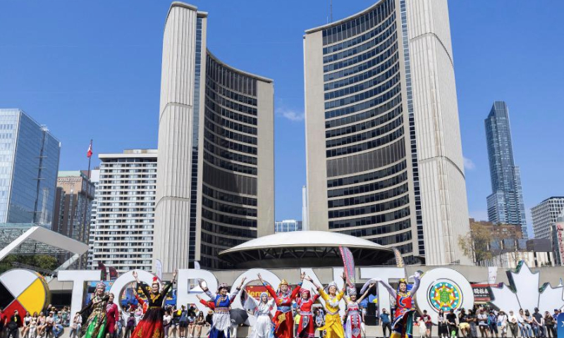 Models present traditional attire of Chinese ethnic minorities during the 2024 Toronto Dragon Festival at Nathan Phillips Square in Toronto, Canada, Sept. 1, 2024. (Photo by Zou Zheng/Xinhua)