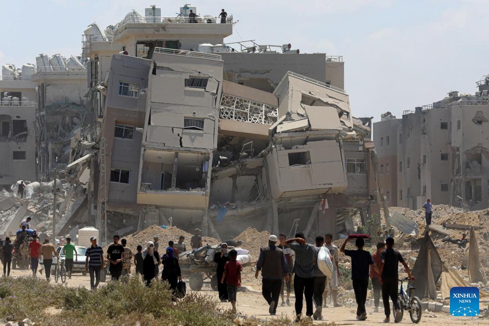 Displaced people return their home in the city of Deir al-Balah, central Gaza Strip, on Aug. 29, 2024. On Thursday, the UN Office for the Coordination of Humanitarian Affairs (OCHA) said Israeli authorities announced that displaced people could return to specific areas in Deir al-Balah, the first time where return is officially allowed to an evacuated area. (Photo: Xinhua)