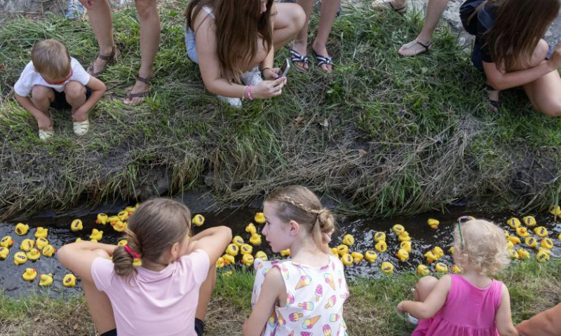 People watch a rubber duck race, also a charity event, in Szentendre, Hungary, on Aug. 31, 2024. (Photo by Attila Volgyi/Xinhua)