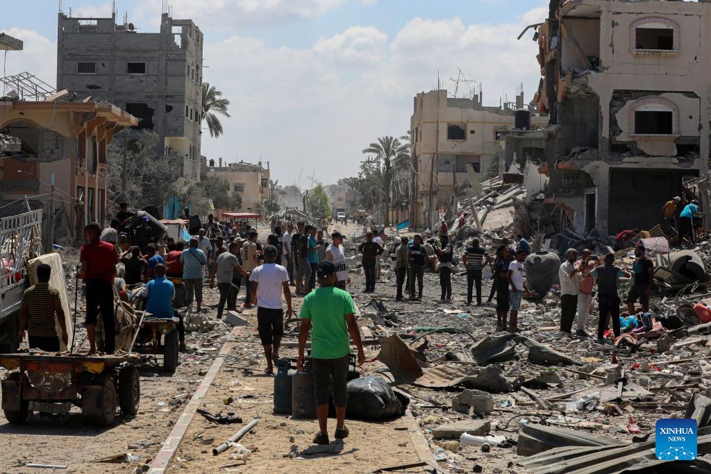 Displaced people return their home in the city of Deir al-Balah, central Gaza Strip, on Aug. 29, 2024. On Thursday, the UN Office for the Coordination of Humanitarian Affairs (OCHA) said Israeli authorities announced that displaced people could return to specific areas in Deir al-Balah, the first time where return is officially allowed to an evacuated area. (Photo: Xinhua)