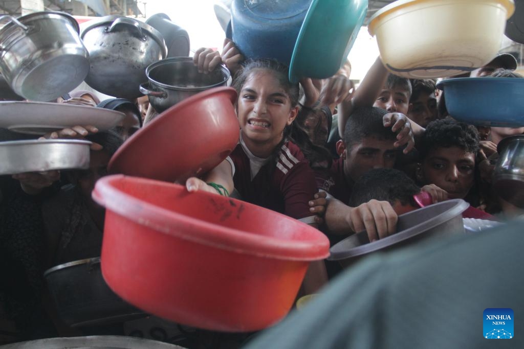 People try to get food relief in Jabalia refugee camp, northern Gaza Strip, on Aug. 29, 2024. Gaza is now in the grip of a severe humanitarian crisis, with millions displaced and necessities such as food, medicine and clean water in critical shortage. In July, UN experts warned that famine has spread throughout the Gaza Strip. (Photo: Xinhua)