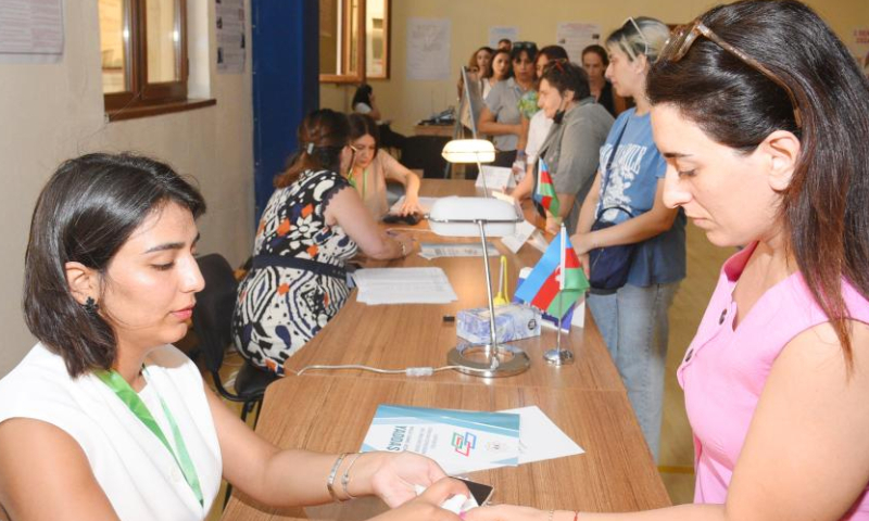 People prepare for voting at a polling station in Baku, Azerbaijan, Sept. 1, 2024. Azerbaijan's snap parliamentary elections began early Sunday. (Photo by Tofik Babayev/Xinhua)