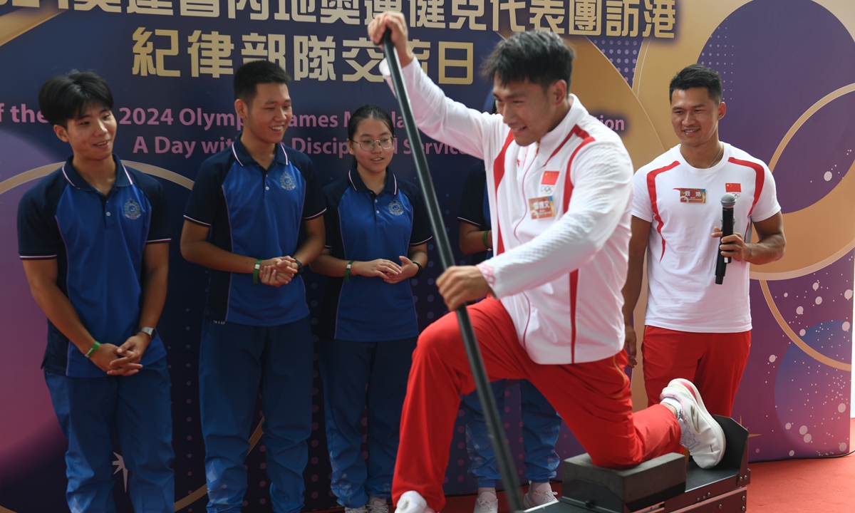 Canoeist Ji Bowen (front) demonstrates some moves during a visit to the Fire and Ambulance Services Academy in Tseung Kwan O, Hong Kong on August 30, 2024. A delegation of Chinese mainland Olympians from the Paris 2024 Olympic Games arrived in Hong Kong on Thursday for a three-day visit. Photo: cnsphoto