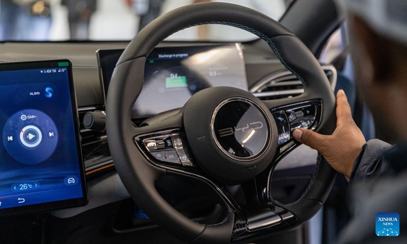 A visitor sits inside an electric vehicle of BYD from China during the Festival of Motoring in Johannesburg, South Africa, Aug. 30, 2024. This event is held here from Aug. 30 to Sept. 1. hoto: Xinhua