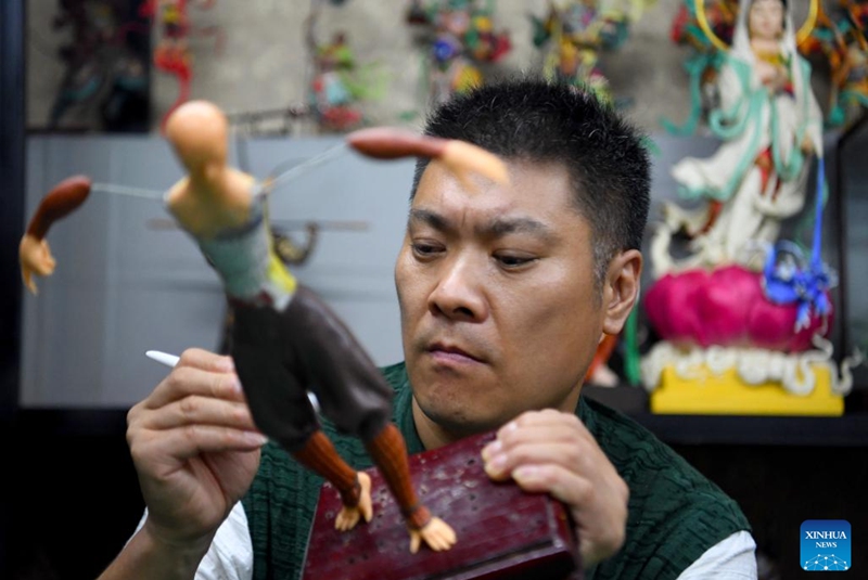 Song Zhanke makes a dough sculpture of Chinese mythological figure the Monkey King or Sun Wukong, at his studio in Luoyang, central China's Henan Province, Aug. 27, 2024. The dough handicraft takes wheat and glutinous rice flour as its main building materials, which are mixed with oil, salt, vinegar and other ingredients. Using hands and simple tools, an artist kneads and pinches the dough to turn it into intricate and lifelike figures.

Song Zhanke, 46, is an inheritor of Song's dough sculpture, a renowned dough handicraft in Luoyang. Having lived by the profession for 20 plus years, the inheritor believes that the figure's body-head proportion, gestures, and facial expressions hold the key to this craft. It is not only the practice of a skill, but also a pursuit and perception of beauty, Song said.

Song hopes that the craft will be better received among younger people and passed down to the future generations. Photo: Xinhua