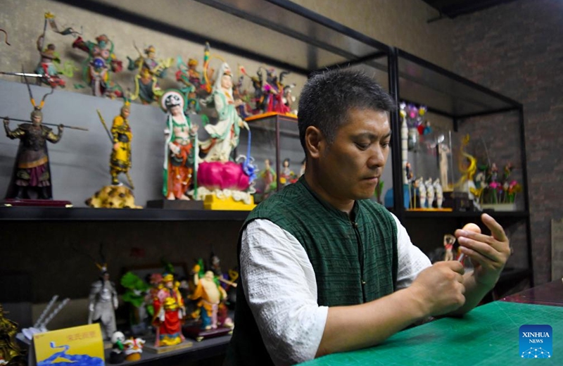 Song Zhanke makes a dough sculpture of Chinese mythological figure the Monkey King or Sun Wukong, at his studio in Luoyang, central China's Henan Province, Aug. 27, 2024. The dough handicraft takes wheat and glutinous rice flour as its main building materials, which are mixed with oil, salt, vinegar and other ingredients. Using hands and simple tools, an artist kneads and pinches the dough to turn it into intricate and lifelike figures.

Song Zhanke, 46, is an inheritor of Song's dough sculpture, a renowned dough handicraft in Luoyang. Having lived by the profession for 20 plus years, the inheritor believes that the figure's body-head proportion, gestures, and facial expressions hold the key to this craft. It is not only the practice of a skill, but also a pursuit and perception of beauty, Song said.

Song hopes that the craft will be better received among younger people and passed down to the future generations. Photo: Xinhua