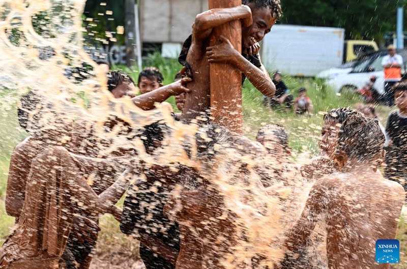 Children participate in a greasy muddy pole climbing game in South Tangerang, Banten Province, Indonesia, Aug. 31, 2024. Photo: Xinhua