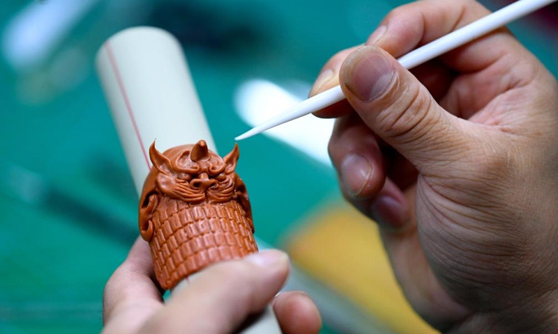 Song Zhanke makes a dough miniature of armour of Chinese mythological figure the Monkey King or Sun Wukong, at his studio in Luoyang, central China's Henan Province, Aug. 27, 2024. The dough handicraft takes wheat and glutinous rice flour as its main building materials, which are mixed with oil, salt, vinegar and other ingredients. Using hands and simple tools, an artist kneads and pinches the dough to turn it into intricate and lifelike figures.

Song Zhanke, 46, is an inheritor of Song's dough sculpture, a renowned dough handicraft in Luoyang. Having lived by the profession for 20 plus years, the inheritor believes that the figure's body-head proportion, gestures, and facial expressions hold the key to this craft. It is not only the practice of a skill, but also a pursuit and perception of beauty, Song said.

Song hopes that the craft will be better received among younger people and passed down to the future generations. Photo: Xinhua