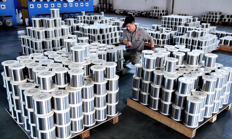 A staff member checks the quality of wire mesh products at an enterprise in Anping, north China's Hebei Province, Aug. 30, 2024. Photo: Xinhua