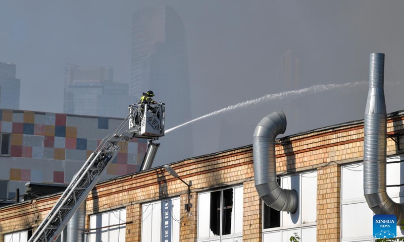 A firefighter works to extinguish a fire at Berezhkovskaya embankment in Moscow, Russia, on Aug. 31, 2024. More than 100 rescue workers with fire-fighting equipment were deployed to contain the blaze that spread across an area of 1,000 square meters, according to the Russian Emergency Situations Ministry. Photo: Xinhua