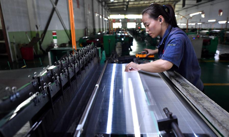 A staff member works at a production line of wire mesh at an enterprise in Anping, north China's Hebei Province, Aug. 30, 2024. Photo: Xinhua