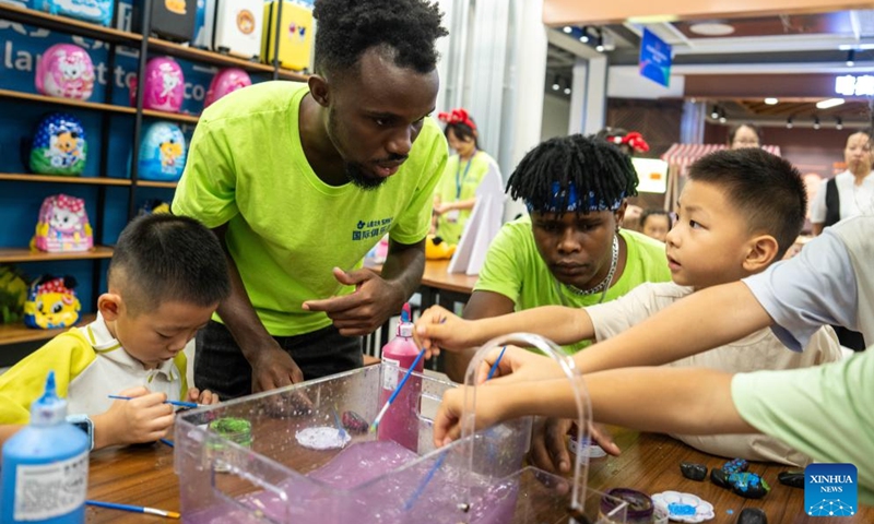 Volunteers introduce stone painting to children during a hands-on experience session at the Malawi pavilion of a permanent exhibition hall of the China-Africa Economic and Trade Cooperation Promotion Innovation Demonstration Park in Changsha, central China's Hunan Province, Aug. 30, 2024. Various activities promoting youth communication between China and Africa were organized here during the summer vacation. With the help of African volunteers from local universities, Chinese students were able to feel the charm of African culture by learning traditional African dance, music, folk arts, and making immersive tours of African customs via VR devices. Photo: Xinhua