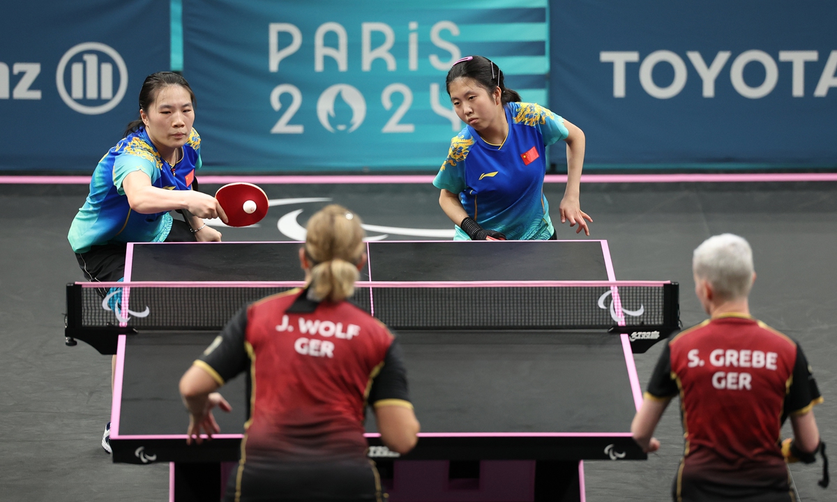 Table tennis players Huang Wenjuan (left) and Jin Yucheng compete during the women’s doubles - WD14 gold medal match at the Paris Paralympic Games on August 30, 2024. Photo: VCG