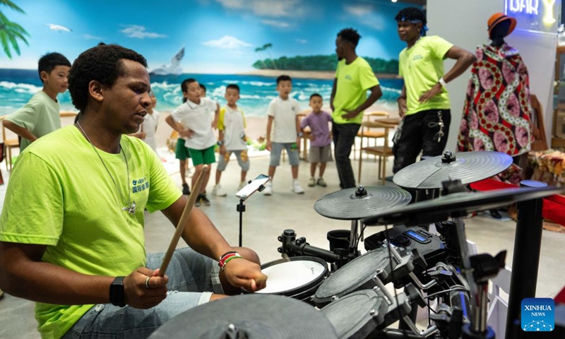 A volunteer demonstrates African music during a hands-on experience session at the Angola pavilion of a permanent exhibition hall of the China-Africa Economic and Trade Cooperation Promotion Innovation Demonstration Park in Changsha, central China's Hunan Province, Aug. 30, 2024. Various activities promoting youth communication between China and Africa were organized here during the summer vacation. With the help of African volunteers from local universities, Chinese students were able to feel the charm of African culture by learning traditional African dance, music, folk arts, and making immersive tours of African customs via VR devices. Photo: Xinhua